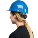 A woman wearing a Cordova blue cap style hard hat with a ponytail.