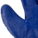 A close up of a Cordova blue and white work glove with blue latex coating on the palm.