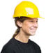 A woman wearing a Cordova yellow hard hat with a smile.