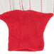 A red and white knitted Cordova work glove.