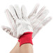 A pair of white gloves with red stripes.