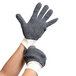 A pair of extra large Cordova polyester and cotton loop-out work gloves on a pair of hands.