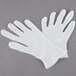 A pair of white Cordova polyester/cotton gloves.