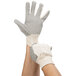 A close-up of a Cordova large work glove with black PVC dotted palms.