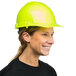A woman wearing a green cap style hard hat with a ratchet suspension.