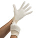 A person's hand wearing a white Cordova jersey glove.