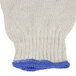 A pair of white cotton work gloves with blue trim.