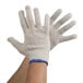 A pair of large Cordova natural cotton work gloves with blue trim on the wrist.