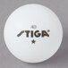A white Stiga ping pong ball with black text on it.