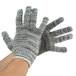 A pair of large Cordova jersey gloves in gray and white.