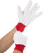 A pair of Cordova work gloves with red and white stripes on the palms.