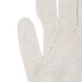 A close up of a Cordova medium weight natural polyester/cotton jersey glove with blue trim.