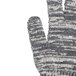 A close up of a Cordova knitted work glove with a gray and white pattern.
