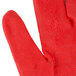 A medium Cordova yellow work glove with a red nitrile palm.