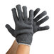 A pair of large gray Cordova jersey work gloves on a pair of hands.