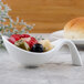 A white Villeroy & Boch porcelain bowl filled with food including olives and vegetables.