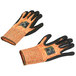 A pair of medium Cordova cut resistant gloves with black and orange trim.
