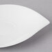 A white Villeroy & Boch porcelain saucer on a gray surface.