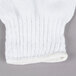 A close up of a white knitted fabric similar to Cordova Standard Weight White Polyester / Cotton Work Gloves.
