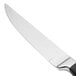 A Walco stainless steel steak knife with a black Delrin plastic handle.