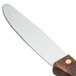 A Walco stainless steel steak knife with a dark hardwood handle.