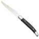 A Walco stainless steel steak knife with a black Delrin handle.