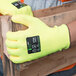 A close-up of a pair of Cordova heavy duty work gloves with yellow polyurethane palm coatings and safety markings.