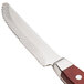 A Walco Denver steak knife with a wooden handle.