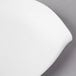 A close-up of a Villeroy & Boch white porcelain flat plate with a curved edge.