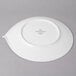 A Villeroy & Boch white porcelain flat plate on a gray surface.
