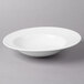 A white Villeroy & Boch porcelain pasta plate on a gray surface.
