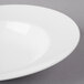 A close-up of a Villeroy & Boch white porcelain pasta plate with a rim.