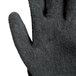 A close up of a Cordova Monarch black work glove with a black latex palm coating.