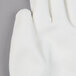 A close up of a Cordova Monarch white engineered fiber work glove with white palm coating.