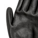 A close-up of a Cordova Monarch black and green engineered fiber work glove with black polyurethane coating.