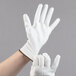 A pair of hands wearing white Cordova Mirage gloves with white Polyurethane palm coating.
