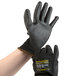 A pair of extra large Cordova Monarch black gloves with black polyurethane palms.
