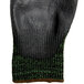 A pair of black Cordova Monarch gloves with green trim.