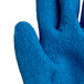 A close up of a Cordova blue cut resistant glove with a white latex palm coating.
