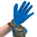 A pair of Cordova blue and green heavy duty work gloves with blue latex palms.