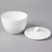 A white Villeroy & Boch porcelain bowl with lid and spoon.