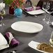 A table set with Villeroy & Boch oval platters, plates, and glasses.