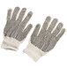 A pair of white Cordova work gloves with black dots on the palms.