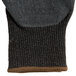 A black Cordova glove with black latex palm coating and brown trim.