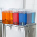 A Crathco beverage dispenser bowl assembly with three different colored liquids.