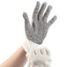A hand wearing a Cordova work glove with white dots on the palm.