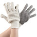 A close-up of a pair of Cordova work gloves with black dots on the palm.