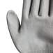 A close-up of a Cordova Monarch work glove with a gray polyurethane palm.