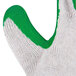 A close-up of a Cordova work glove with green latex palm coating and green thumb.