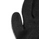 A close up of a Cordova black and gray warehouse glove with black latex coating on the palm.
